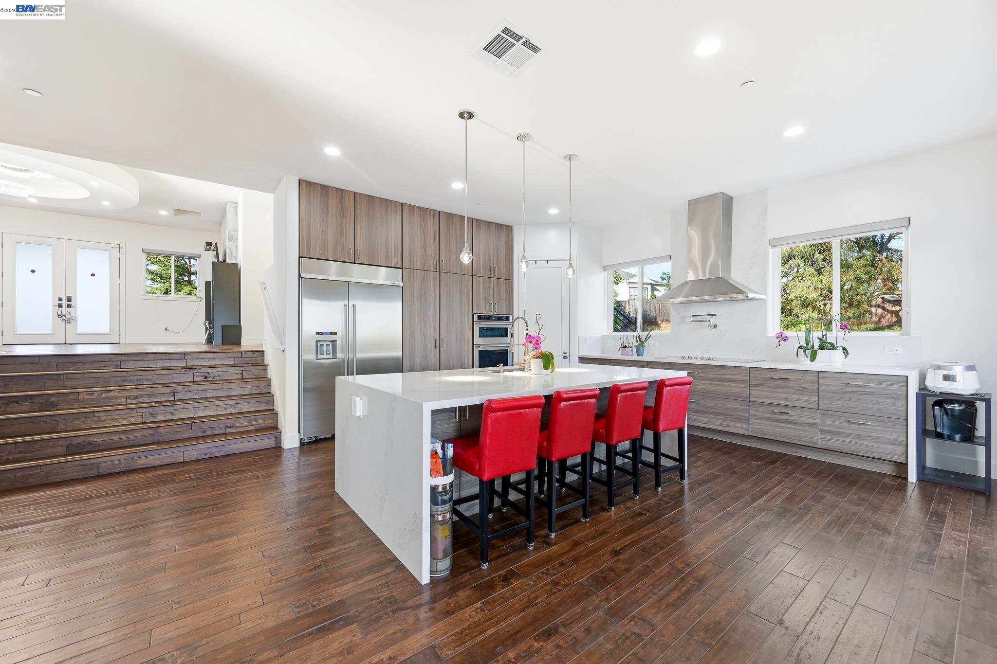 4683 Proctor Road Castro Valley, CA 94546 - Photo 16 of 88 a large kitchen with a table chairs wooden floor and a window