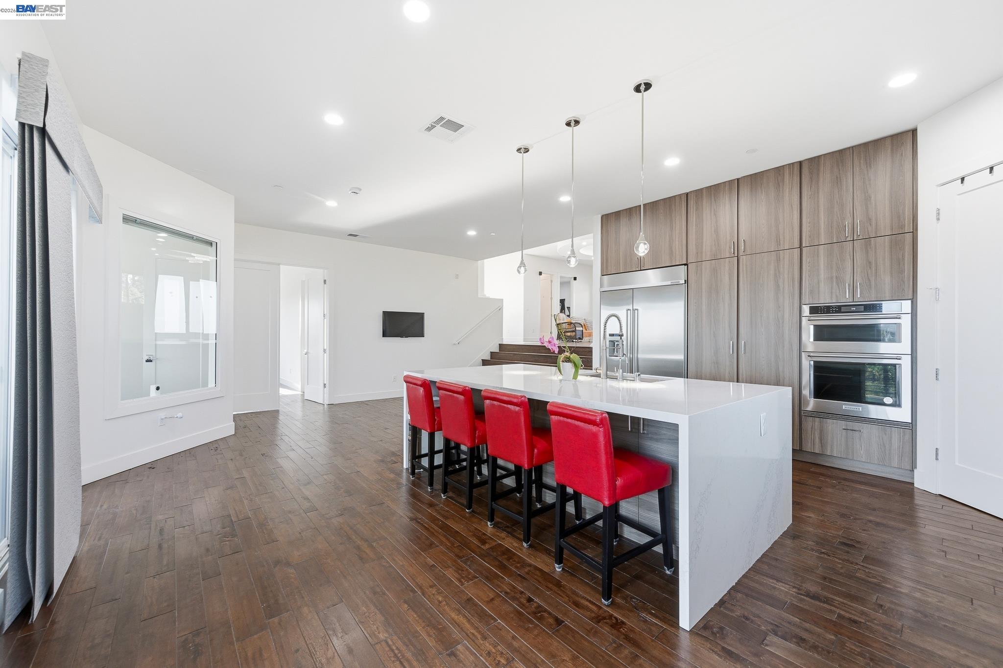 4683 Proctor Road Castro Valley, CA 94546 - Photo 18 of 88 a kitchen with stainless steel appliances kitchen island granite countertop a stove a sink dishwasher and a refrigerator with wooden floor
