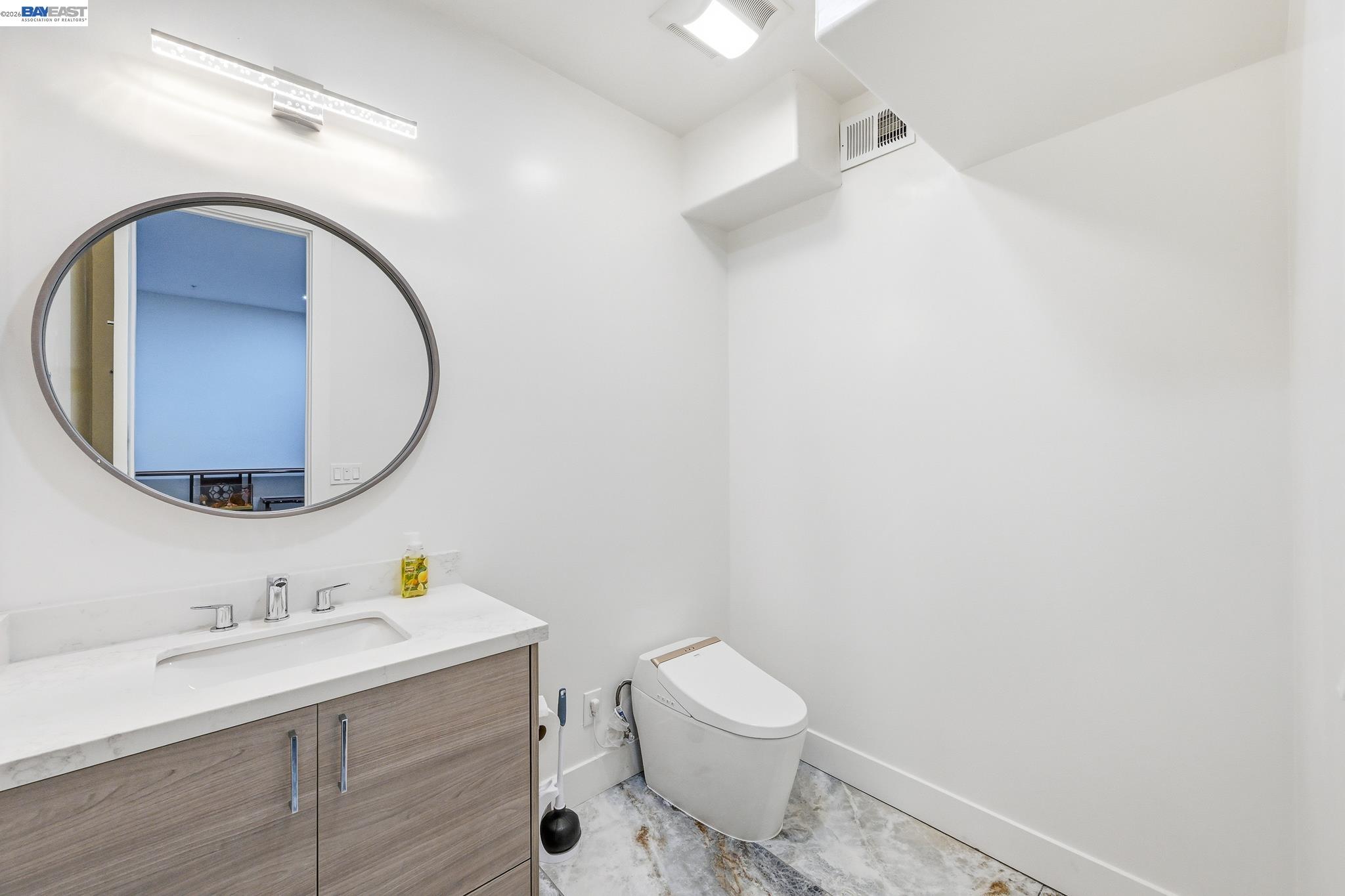 4683 Proctor Road Castro Valley, CA 94546 - Photo 48 of 88 a bathroom with a sink mirror vanity and toilet