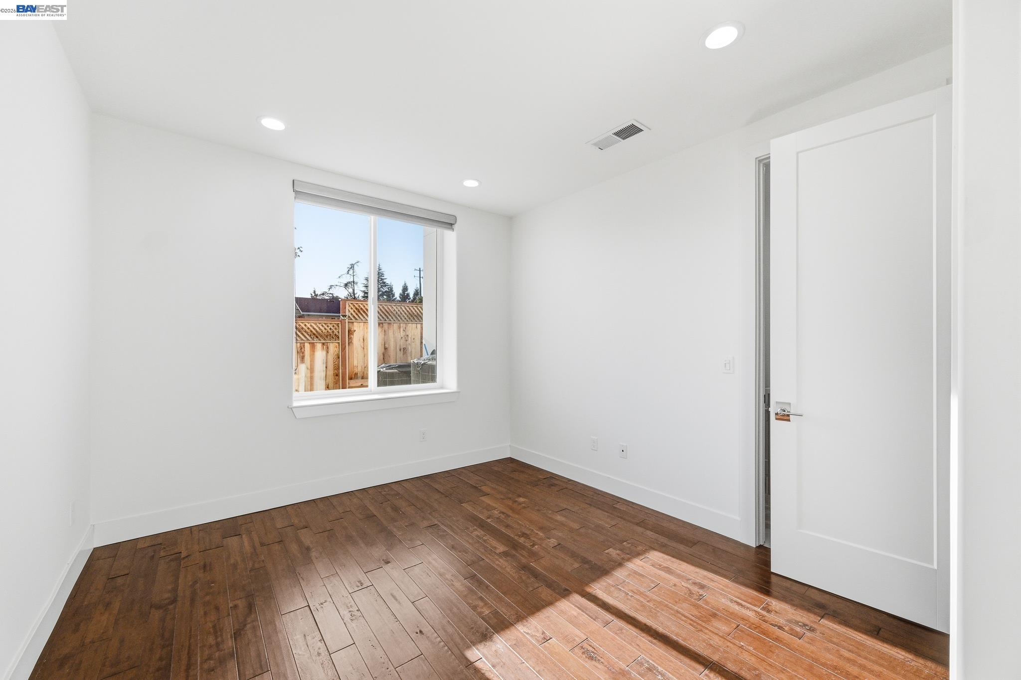 4683 Proctor Road Castro Valley, CA 94546 - Photo 54 of 88 a view of an empty room with wooden floor and a window