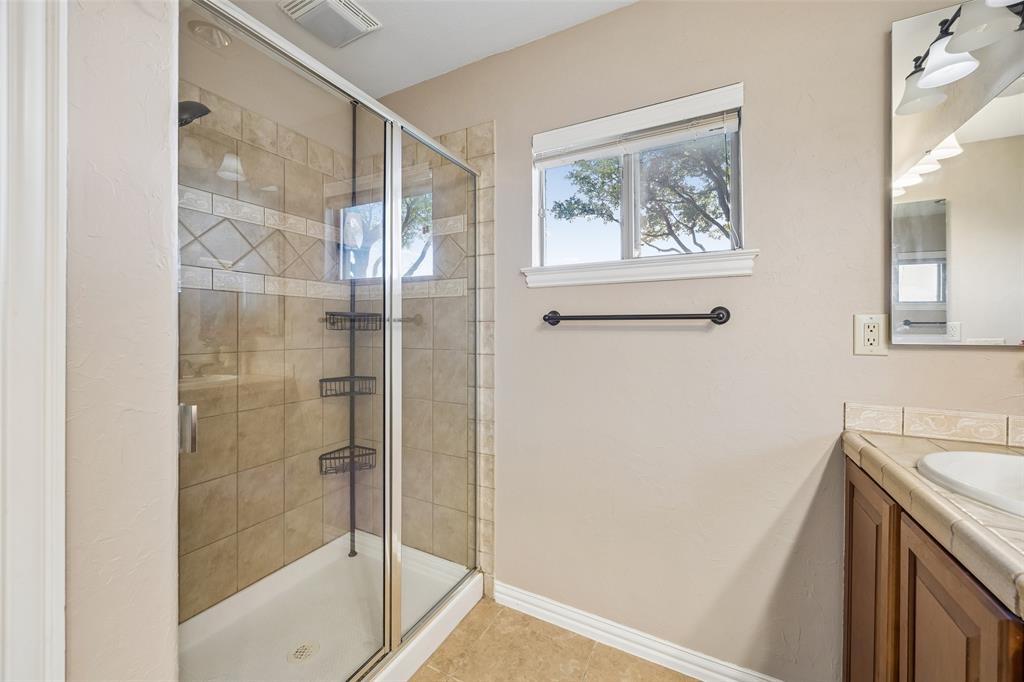 9221 Perimeter Street Denton, TX 76207 - Photo 23 of 36 a bathroom with a shower and a sink