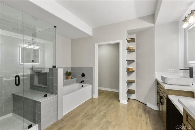 a bathroom with a tub sink and mirror