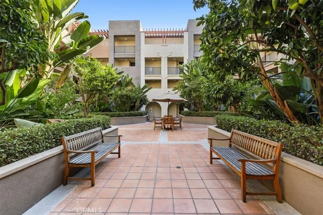 a view of a dining room and livingroom with furniture wooden floor and a rug