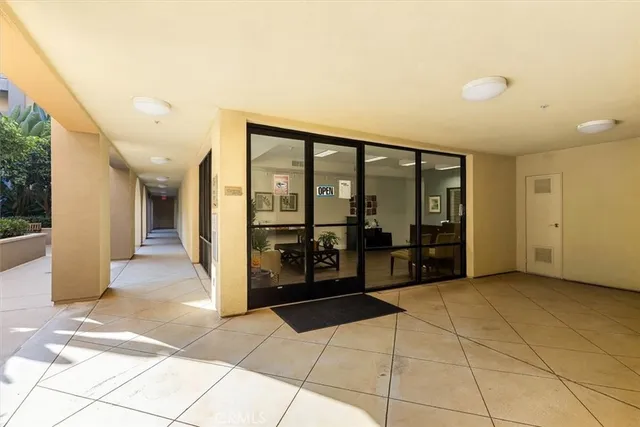 a living room with lots of furniture and kitchen view