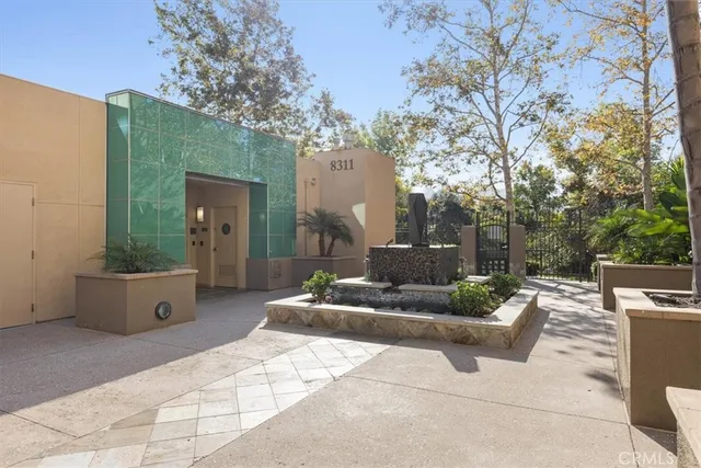 a room with lots of furniture a rug and a chandelier
