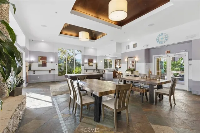 a living room with patio furniture and a potted plant