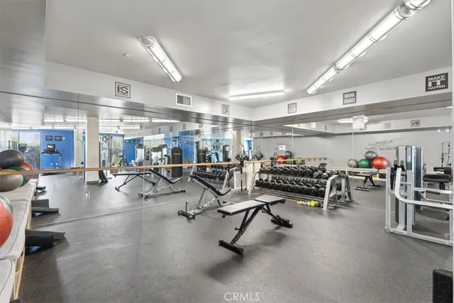 a front view of a house with plants and trees