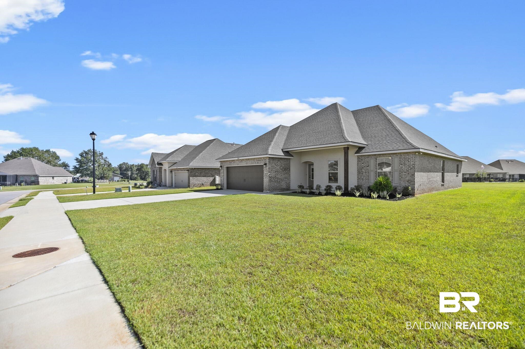 10140 Chipper Lane Foley, AL 36535 - Photo 3 of 72 View of front facade featuring a garage and a front yard