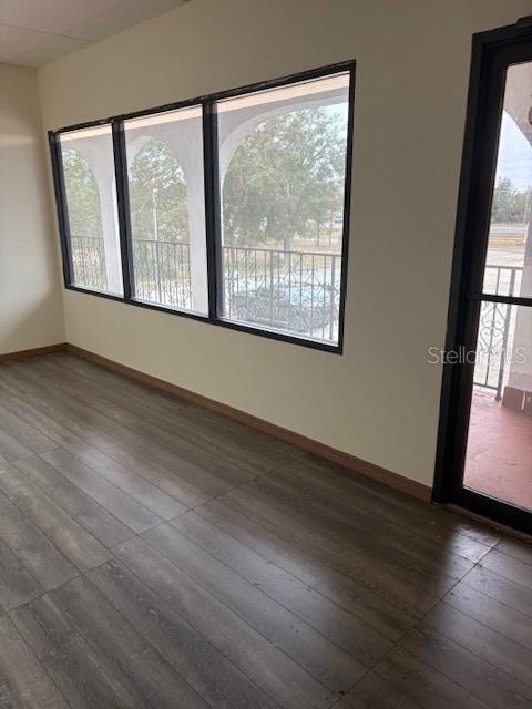 4546 Commercial Way Spring Hill, FL 34606 - Photo 2 of 10 a view of an empty room with wooden floor and a window