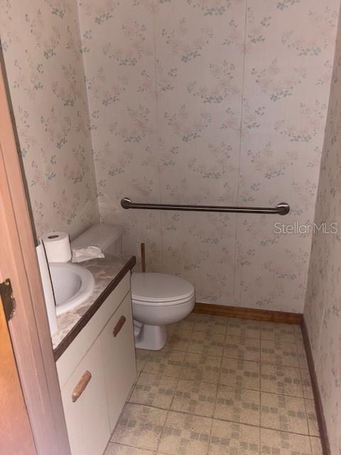 4546 Commercial Way Spring Hill, FL 34606 - Photo 10 of 10 a bathroom with a granite countertop toilet and a sink