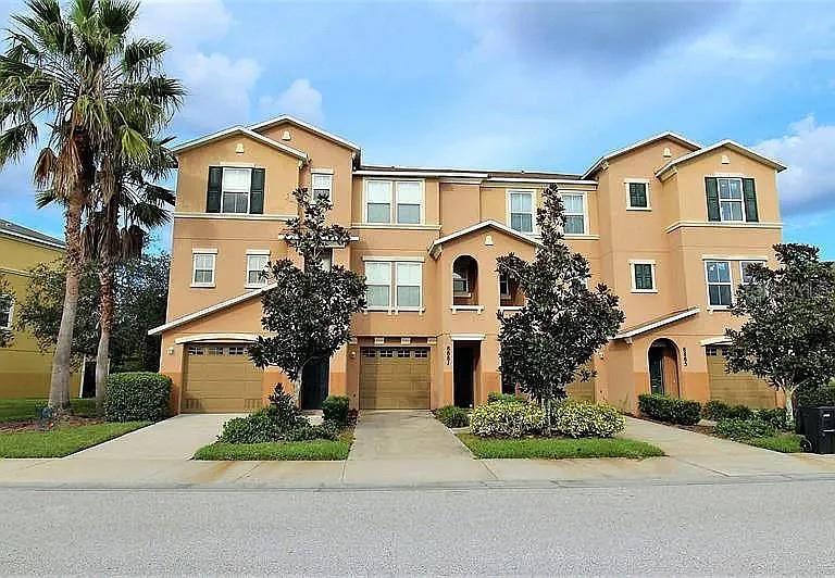 a front view of a house with a garden and plants