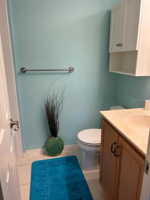 8807 White Sage Loop Lakewood Ranch, FL 34202 - Photo 12 of 19 a bathroom with a granite countertop sink a toilet and a shower