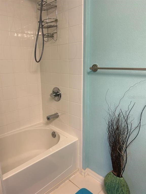 8807 White Sage Loop Lakewood Ranch, FL 34202 - Photo 13 of 19 a bathroom with a bathtub a shower and a plant