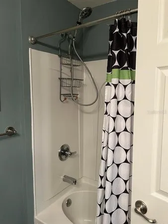 a bathroom with a shower and a sink