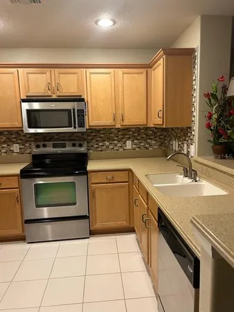 a kitchen with a stove microwave and cabinets