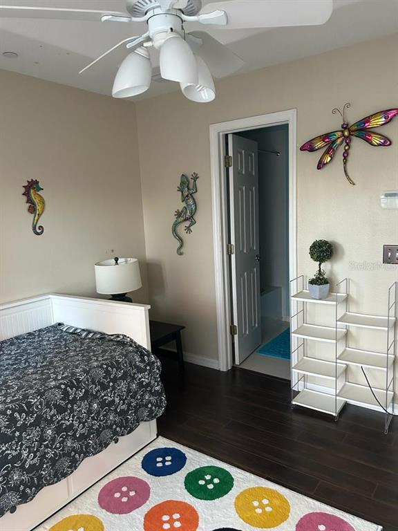 8807 White Sage Loop Lakewood Ranch, FL 34202 - Photo 8 of 19 a bedroom with a bed and wooden floor