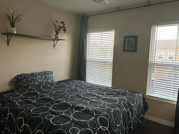 a bedroom with a bed and a window