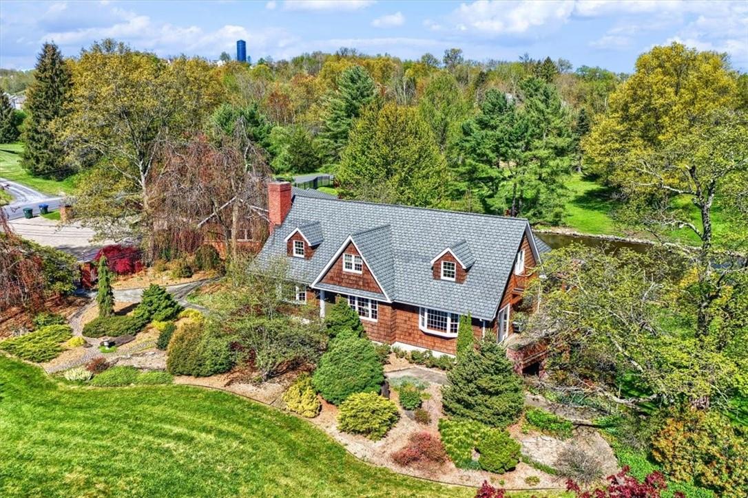an aerial view of a house with a yard and garden