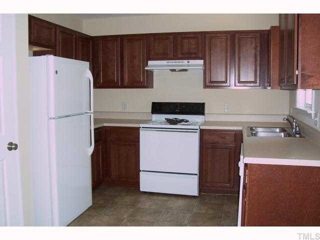 293 Trail Ridge Drive Benson, NC 27504 - Photo 5 of 10 a kitchen with a refrigerator sink stove and cabinets