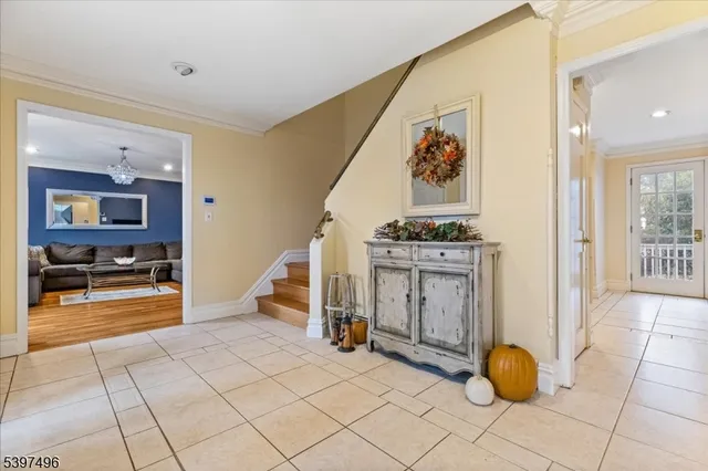 a room with furniture pool table wooden floor and windows