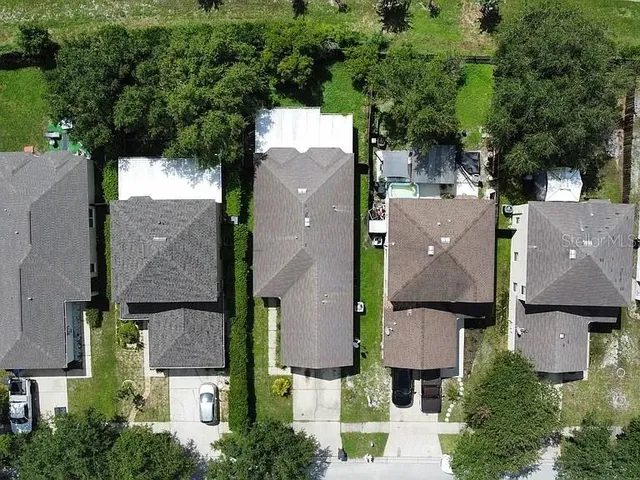 an aerial view of residential houses with outdoor space and street view