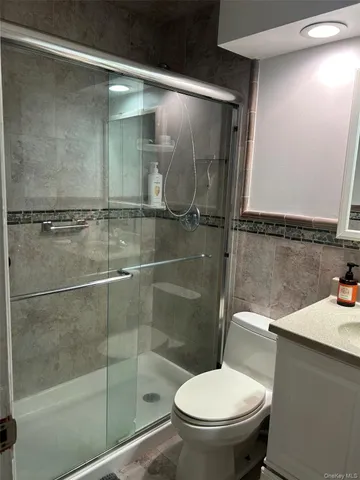 a bathroom with a toilet and a shower