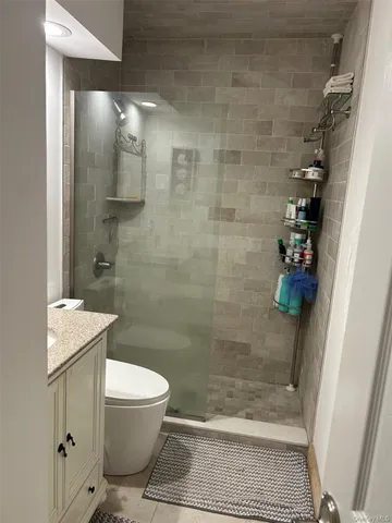 a bathroom with a toilet and shower