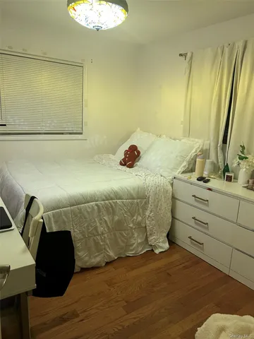 a bedroom with a bed and a mirror