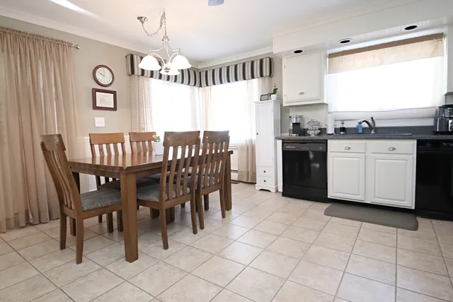 a kitchen with granite countertop a sink cabinets and stainless steel appliances