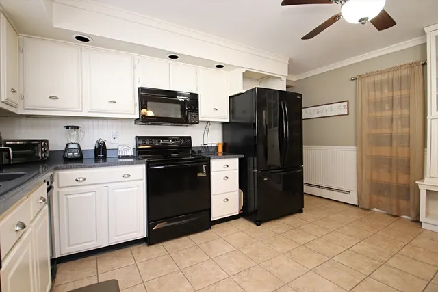 a kitchen with a refrigerator and a stove top oven