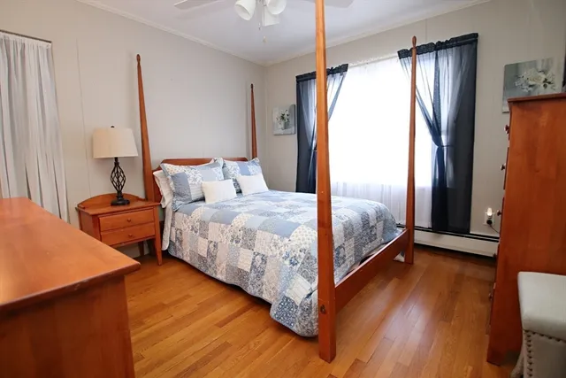 a bedroom with a bed a flat screen tv and window