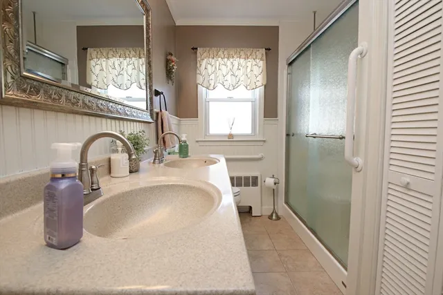 a view of a hallway with wooden floor and windows