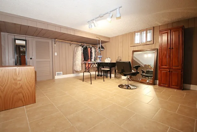 a view of a workspace with furniture and window