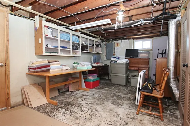 a storage room with stainless steel appliances kitchen island granite countertop furniture and a wooden floors