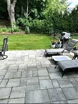 a front view of a house with a garden and trees