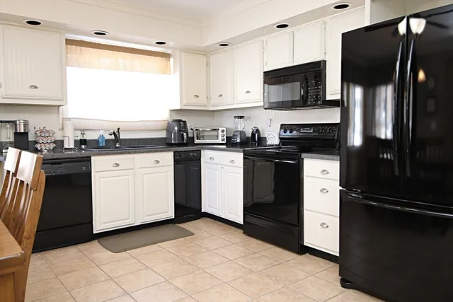 a kitchen with a sink stove and refrigerator