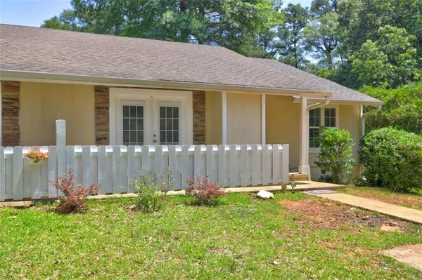 a front view of a house with garden