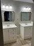 a bathroom with 2 sink and a mirror