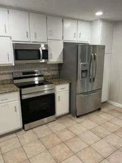 a kitchen with appliances and cabinets