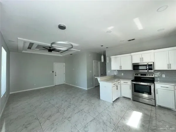 a kitchen with a sink stainless steel appliances and cabinets