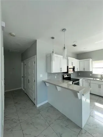a kitchen with stainless steel appliances a refrigerator sink and cabinets