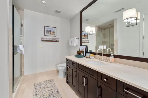 a spacious bathroom with a double vanity sink and a mirror