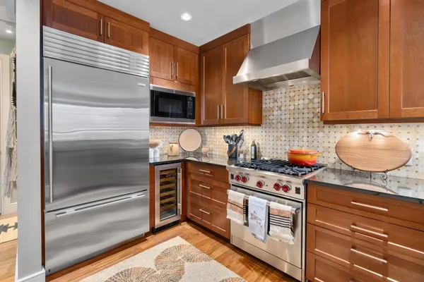 a kitchen with stainless steel appliances granite countertop a stove and a microwave