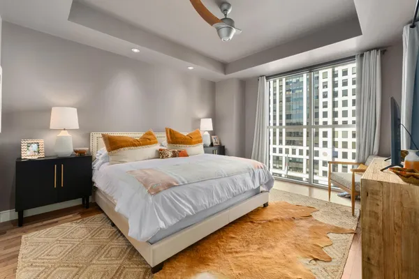 a bedroom with a bed and wooden floor