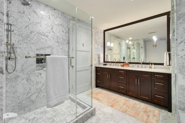 a bathroom with a granite countertop sink a toilet and a mirror