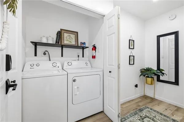 a view of storage and utility room with washer and dryer
