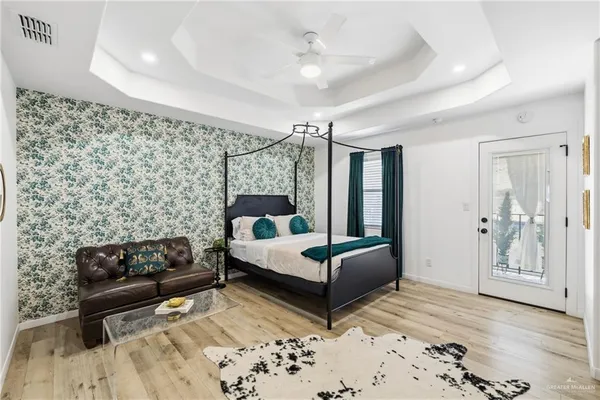 a bedroom with a bed window and potted plant