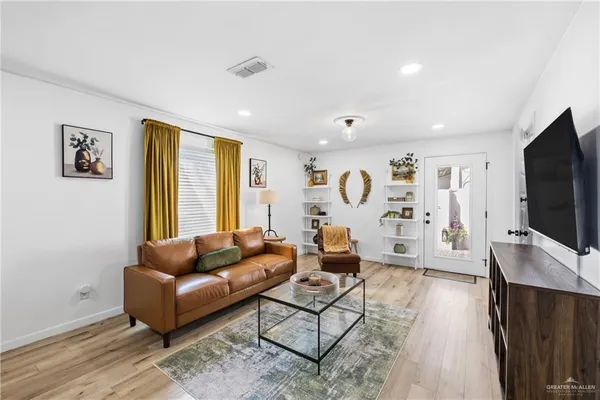 a living room with furniture and a flat screen tv