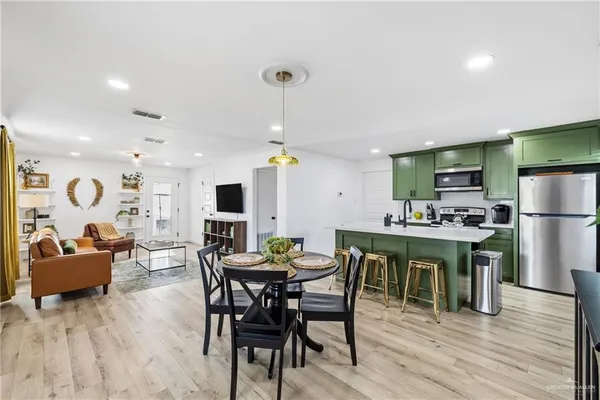 a view of a dining room with furniture and wooden floor