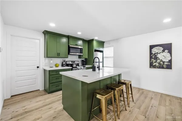 a view of kitchen island with furniture wooden floor and windows